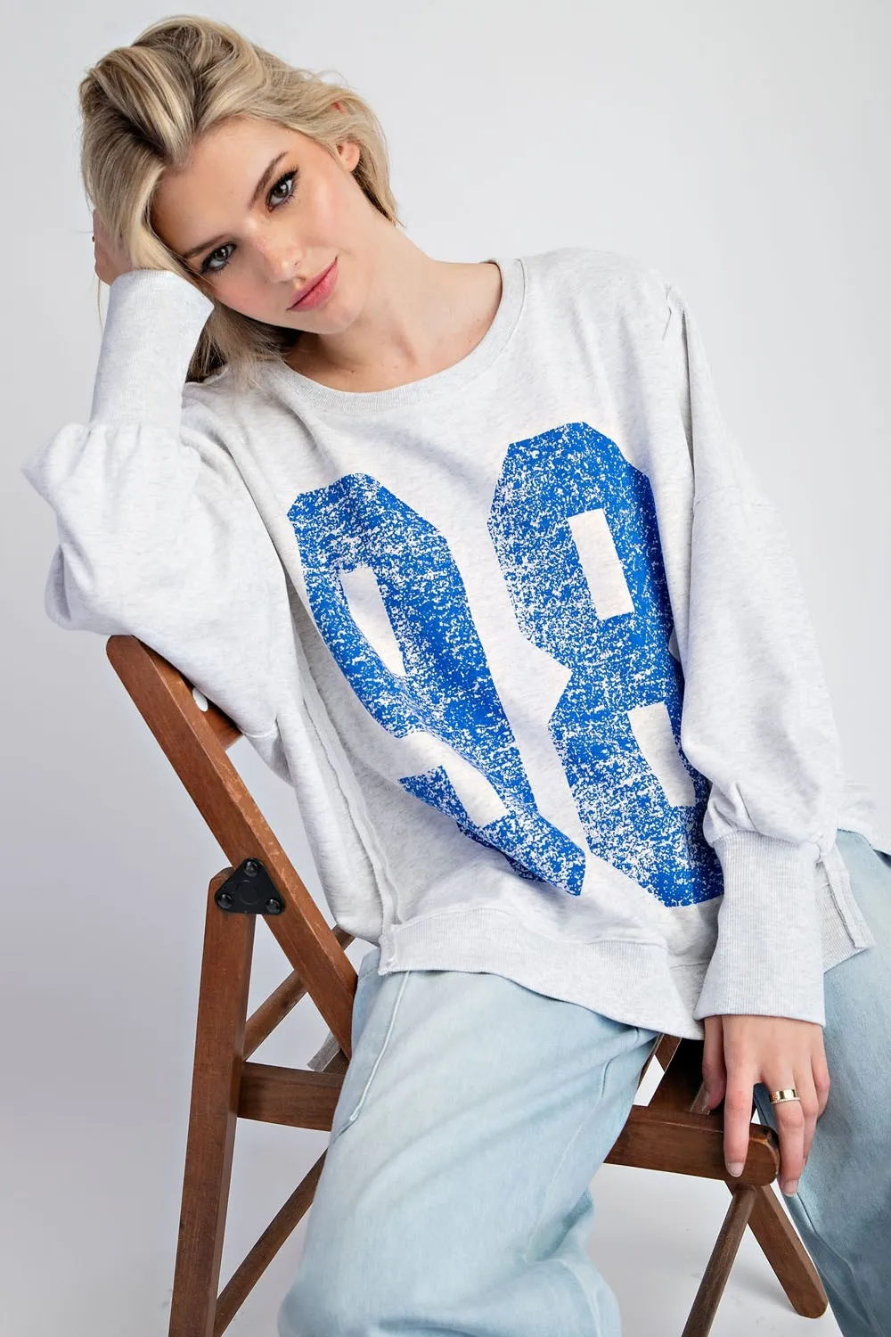 Faded varsity print long sleeve pullover top